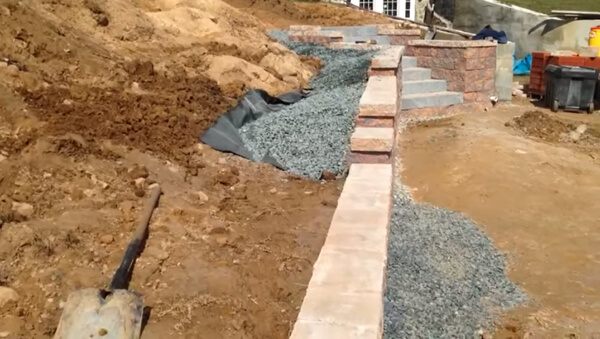 what do you use to backfill a retaining wall